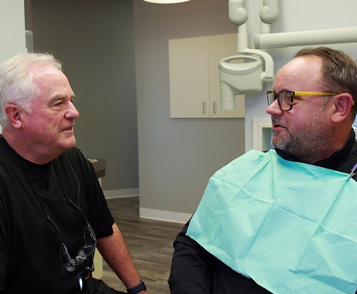 Doctor Walton talking to a patient in the dental chair