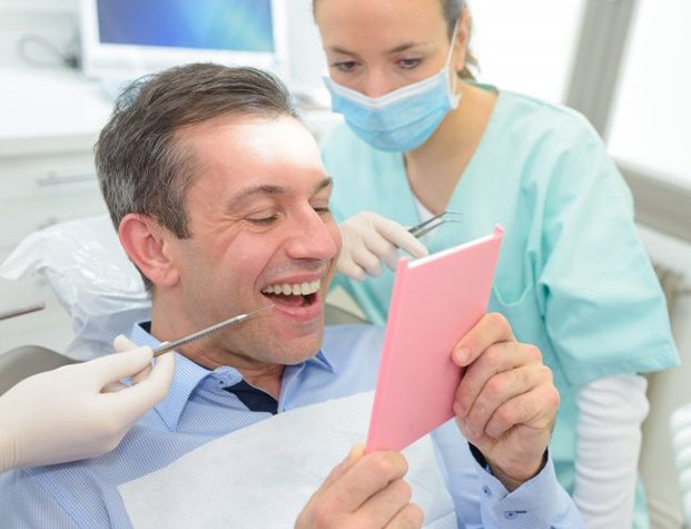 Dentures patient in Upper Arlington smiling at dentist