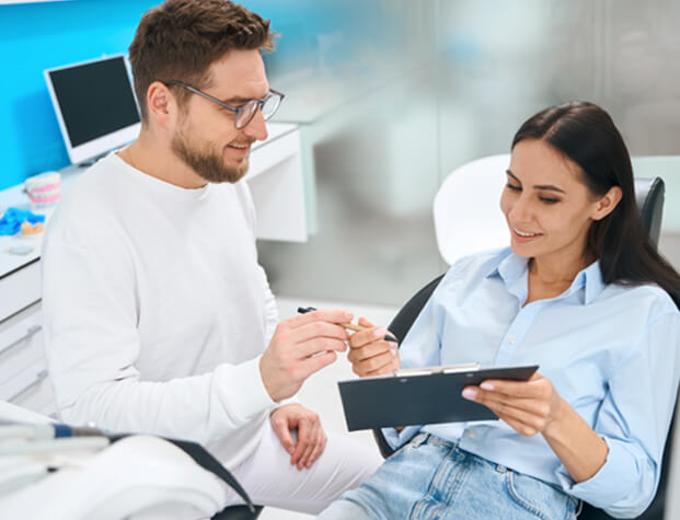 A patient consulting her dentist about the cost of wisdom tooth extractions